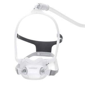 Philips DreamWear Full Face CPAP Mask with headgear and under-the-nose cushion design, connected to tubing.